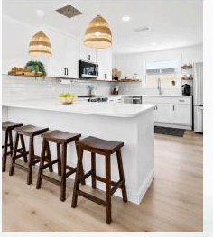 Bright coastal kitchen with woven pendant lighting and counter seating